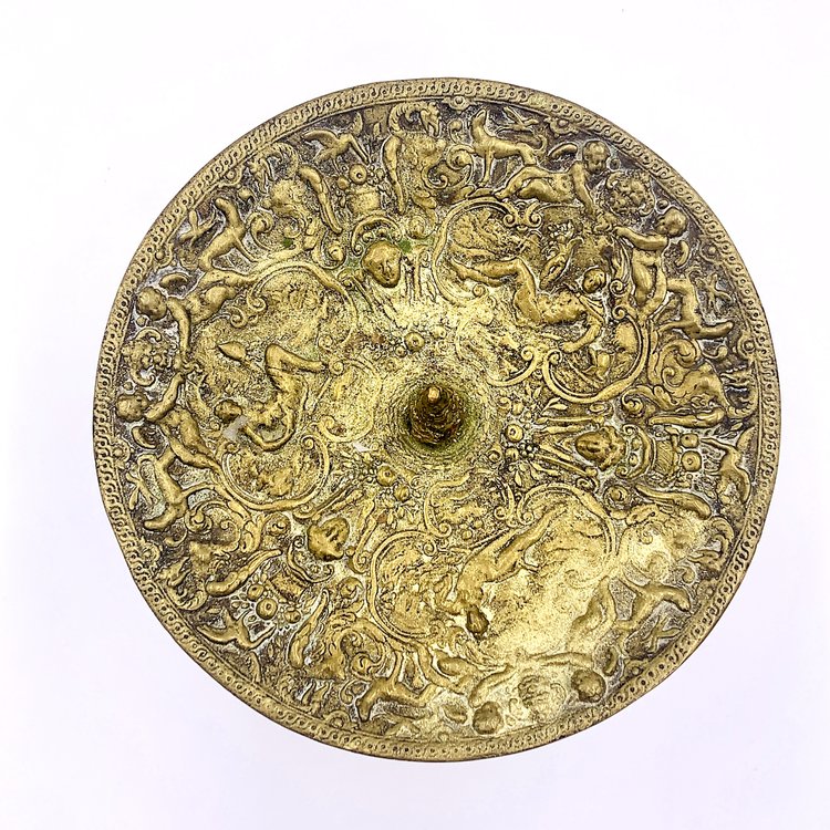 A TAKAYASATO.COM candle holder crafted from brass, with a design on it.