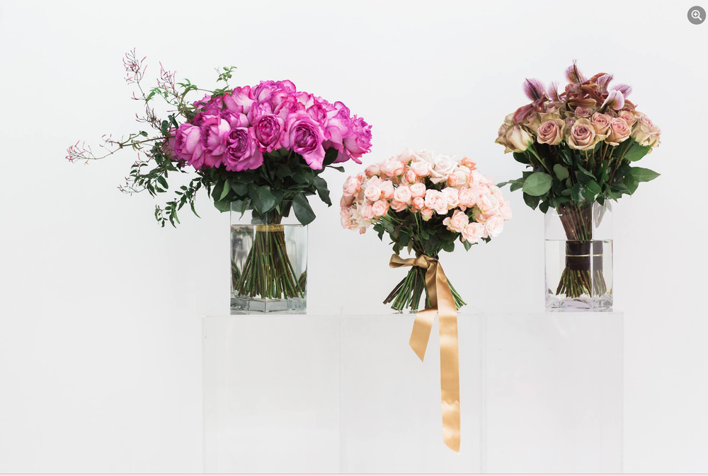 Three MONOFLOWER flowers in vases on a white background by TAKAYASATO.COM.
