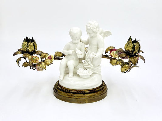 A candle holder of angels with a bird made from porcelain and brass by TAKAYASATO.COM