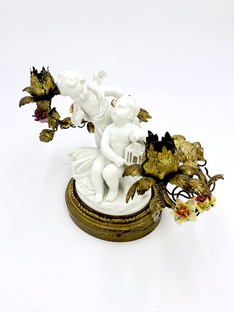 A candle holder of angels with the cage made of porcelain and brass by TAKAYASATO.COM.
