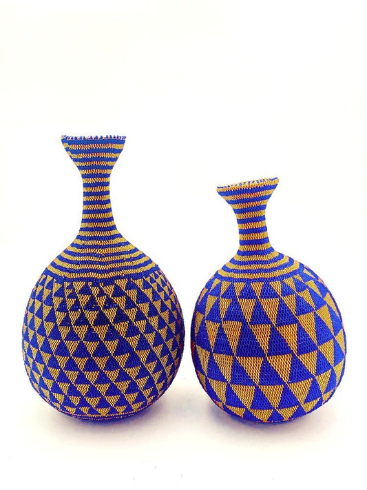 A pair of beaded decorative vases by TAKAYASATO.COM on a white surface