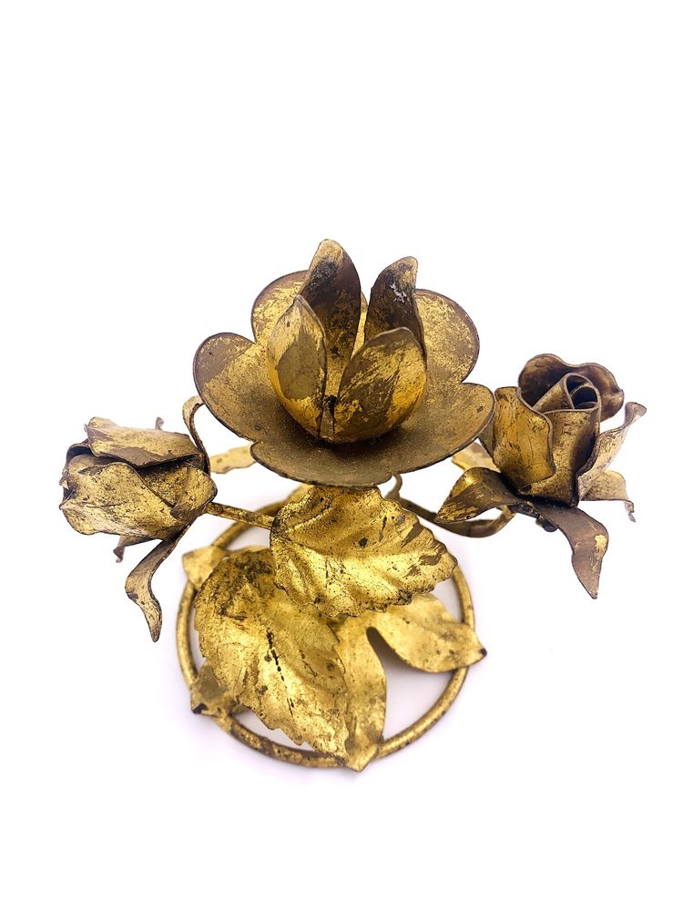 A Pair of Brass Candle Holders with flowers on it by TAKAYASATO.COM