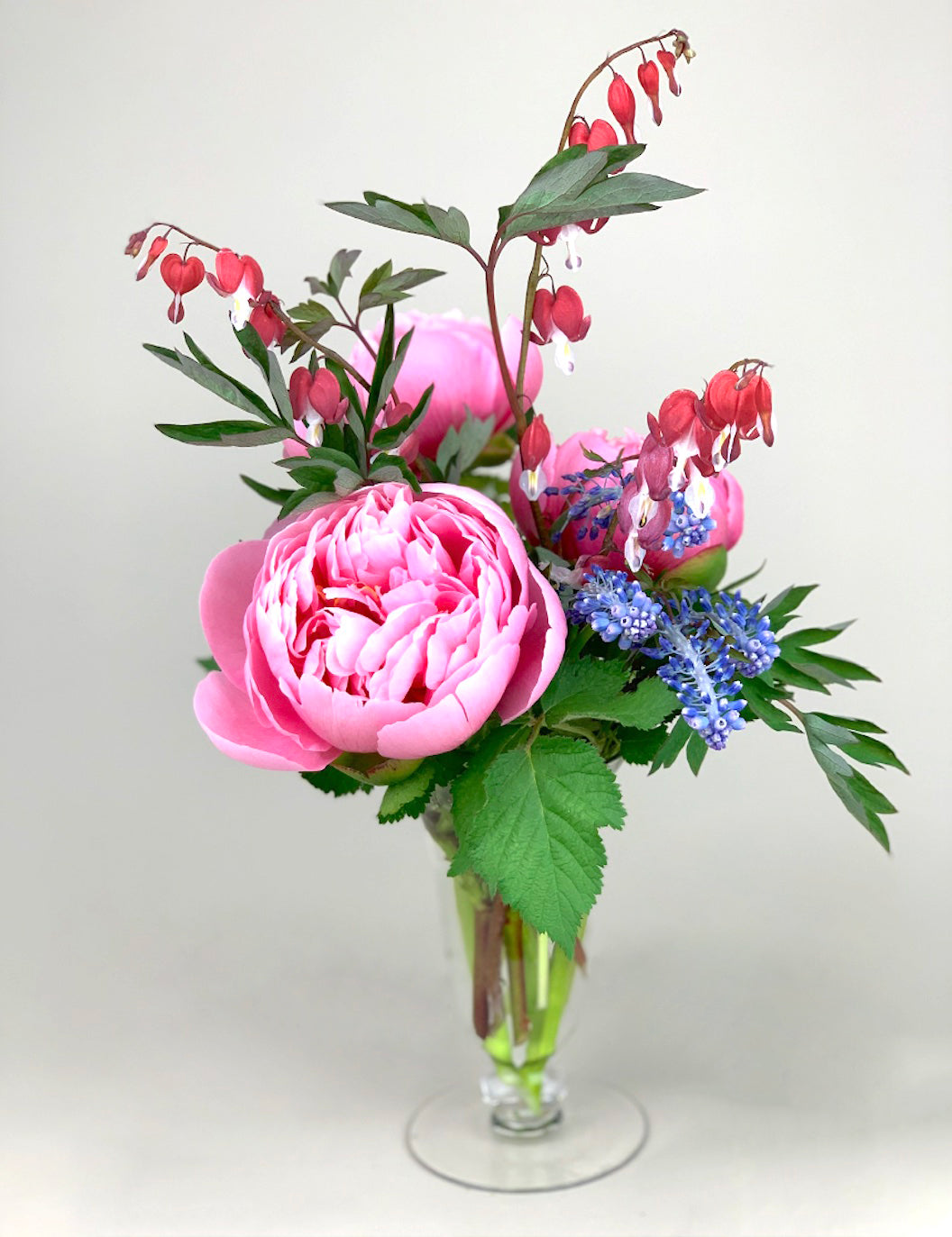 Premium blooms, pink peony and blue lilies make up this Petit arrangement in a clear glass vase from Takayasato.com.