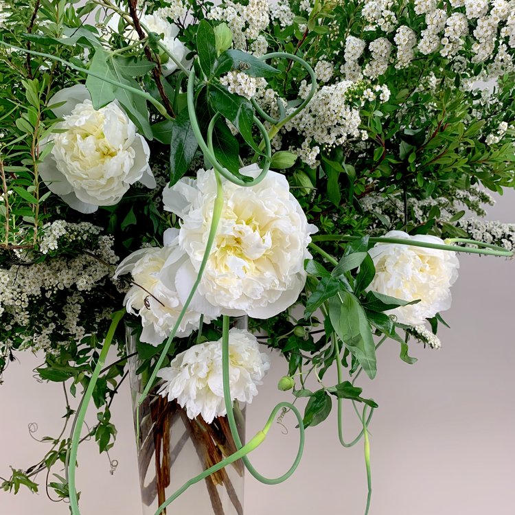 A vase filled with WHITE,GREEN & HERBS flowers in a beautiful TAKAYASATO.COM arrangement.