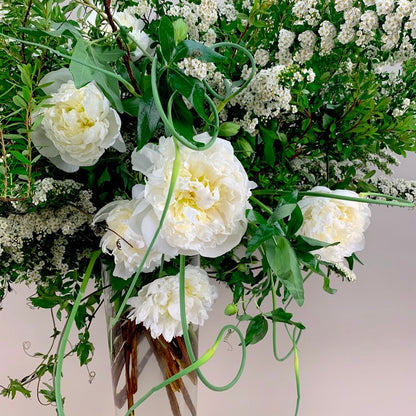 A vase filled with WHITE,GREEN & HERBS flowers in a beautiful TAKAYASATO.COM arrangement.