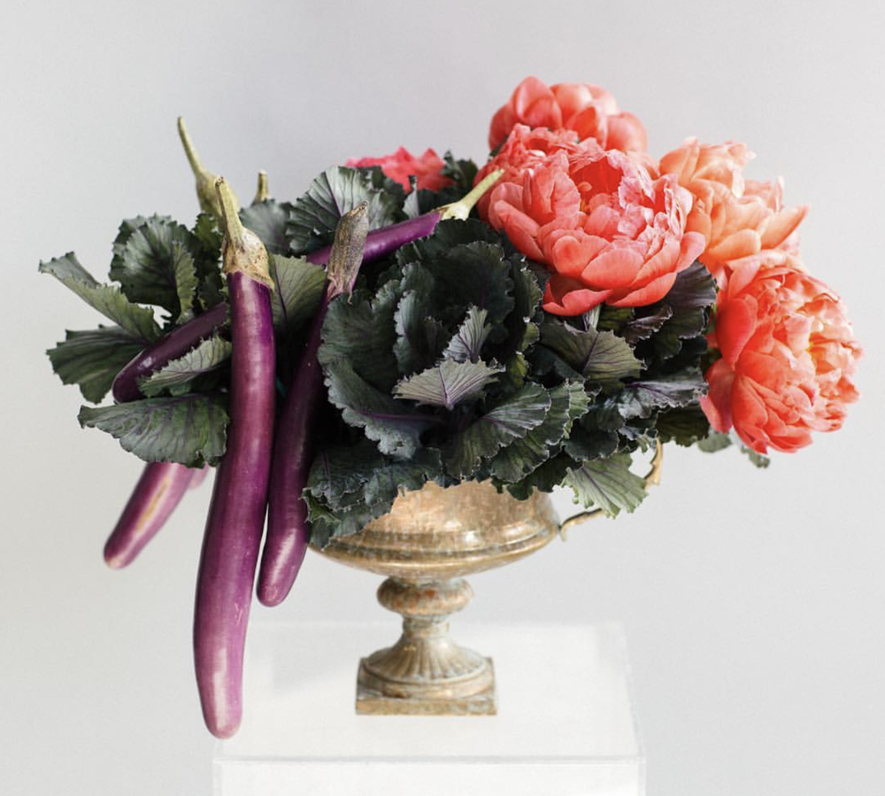A vase filled with ECCENTRIC purple and pink floral arrangements from TAKAYASATO.COM.