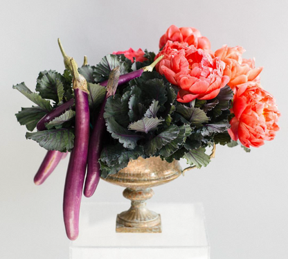 A vase filled with ECCENTRIC purple and pink floral arrangements from TAKAYASATO.COM.