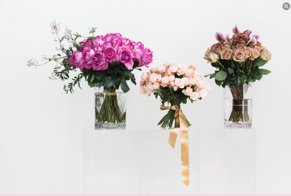 Three MONOFLOWER flowers in vases on a white background by TAKAYASATO.COM.