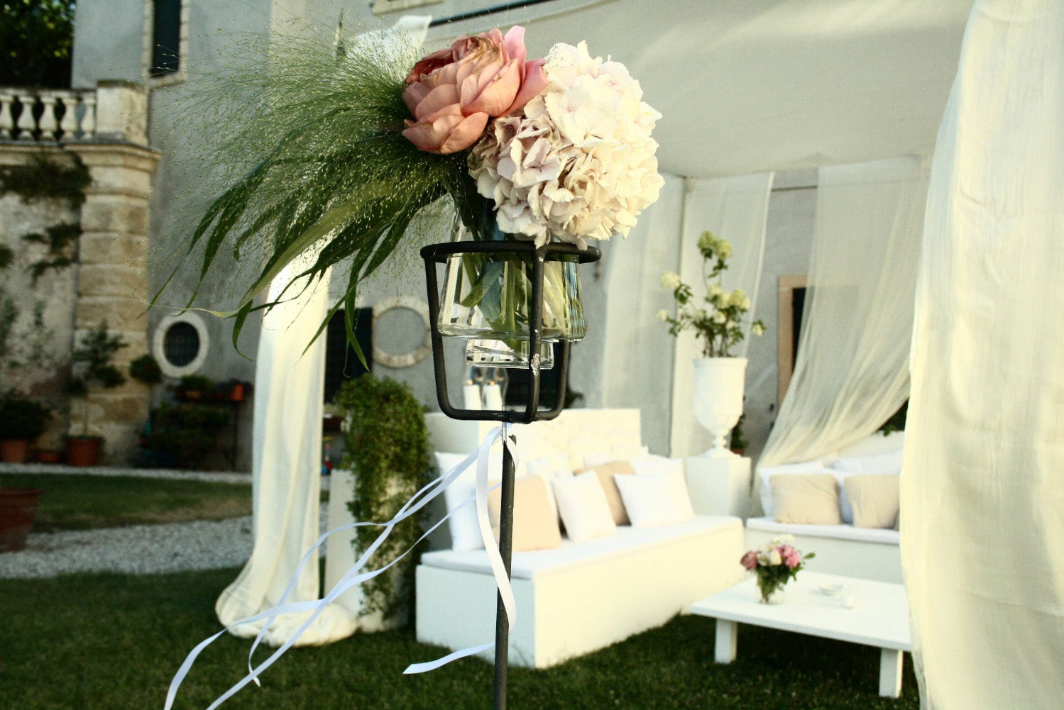 A wedding venue with white and pink floral arrangements decor.