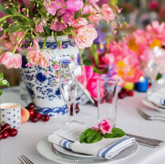 A table setting with blue and pink flowers.