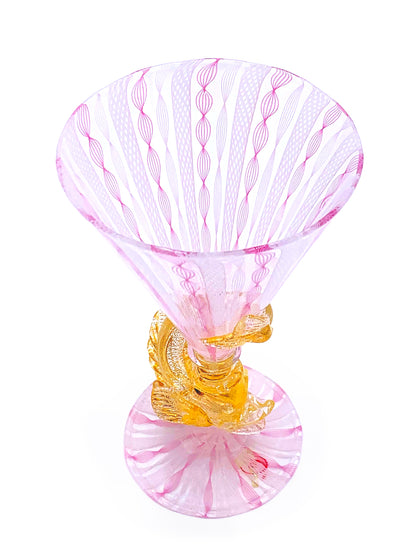 A handcrafted pink Murano Delfino D'Oro martini glass on a white background by TAKAYASATO.COM.