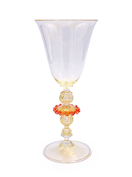 A clear glass wine glass with a red and yellow Murano Merletto Rosa bead showcasing high-quality craftsmanship from Venice by TAKAYASATO.COM.