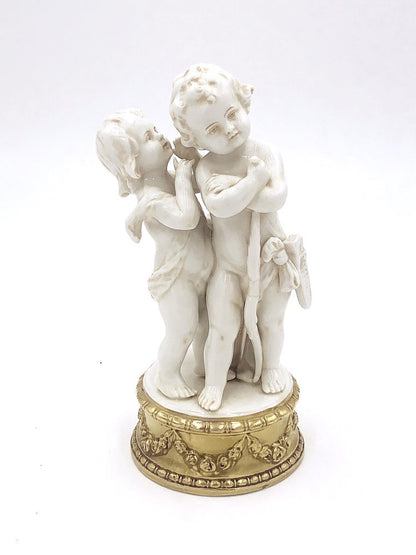 A pair of Angels with arrow figurines on a gold base by TAKAYASATO.COM.