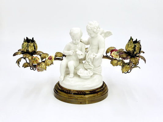 A candle holder of angels with a bird made from porcelain and brass by TAKAYASATO.COM.