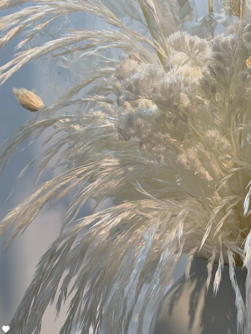 An Eternal arrangement of white flowers in a vase with an artistic flair by TAKAYASATO.COM.