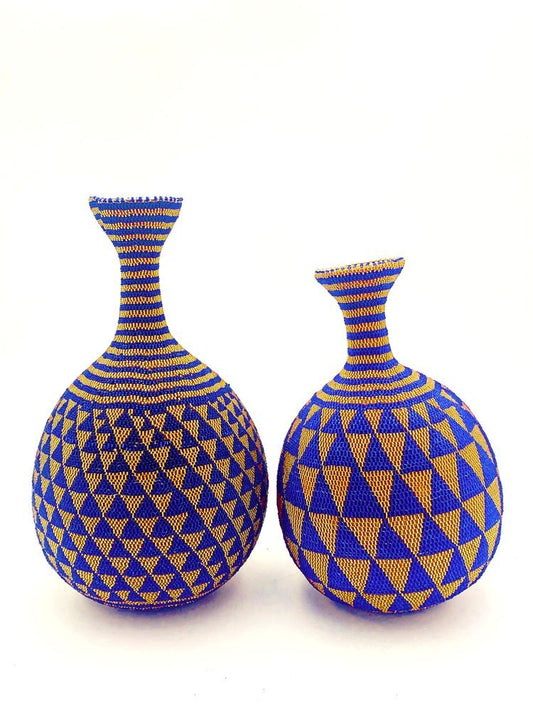 A pair of beaded decorative vases by TAKAYASATO.COM on a white surface.